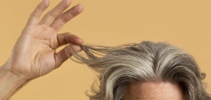 elder-man-holding-his-gray-hair